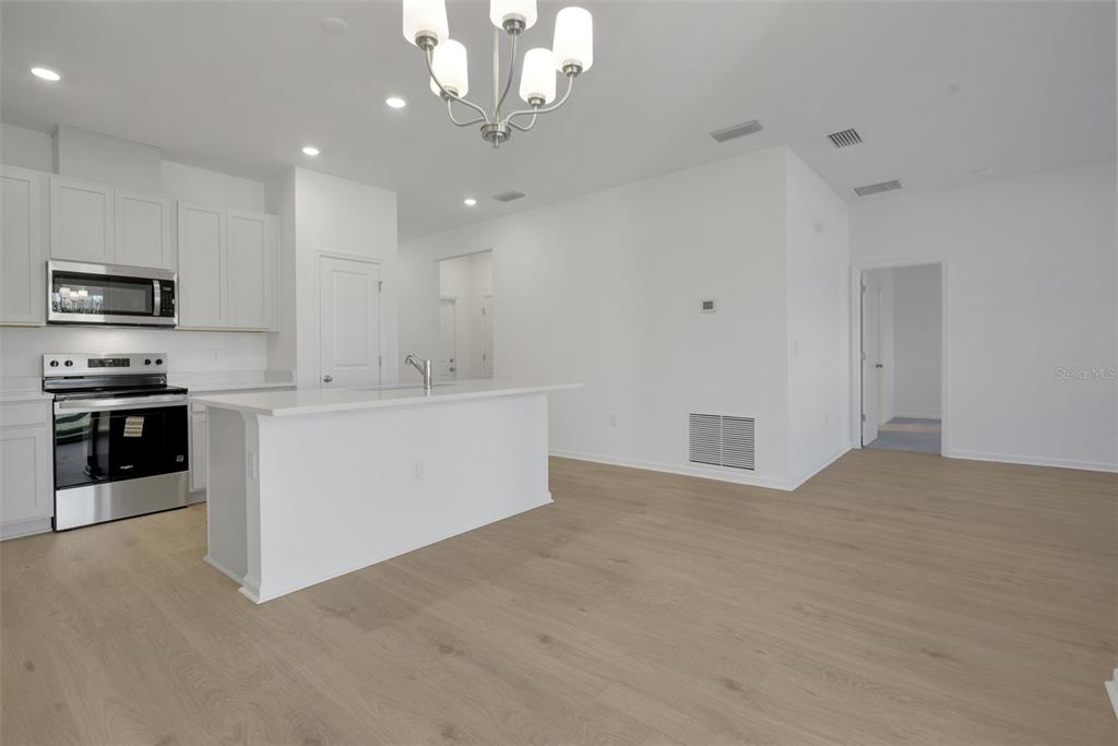 2824 Doolittle Street Tavares, FL 32778 - Photo 19 of 32 a view of a kitchen with a sink wooden floor and windows