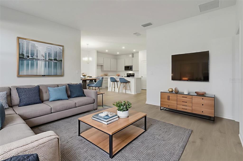 2824 Doolittle Street Tavares, FL 32778 - Photo 9 of 32 a living room with furniture and a flat screen tv