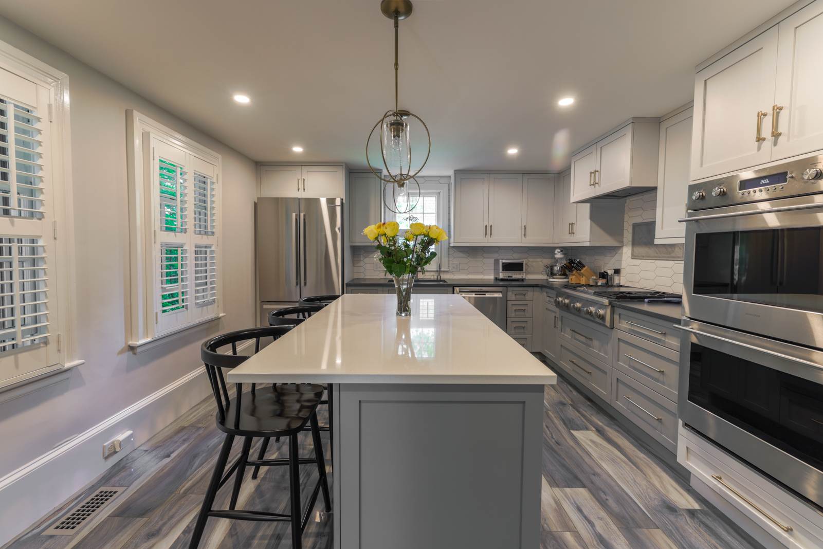 12 Hussey Street Nantucket, MA 02554 - Photo 7 of 47 a kitchen with stainless steel appliances granite countertop a kitchen island a stove a table and chairs