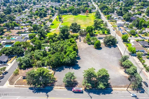 an aerial view of a houses with yard