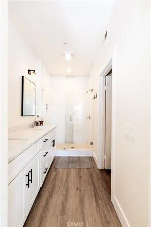 a spacious bathroom with a double vanity sink and mirror