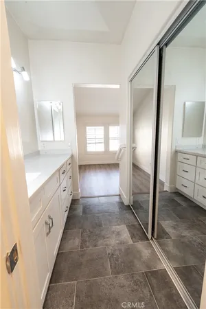 a bathroom with double vanity and a mirror