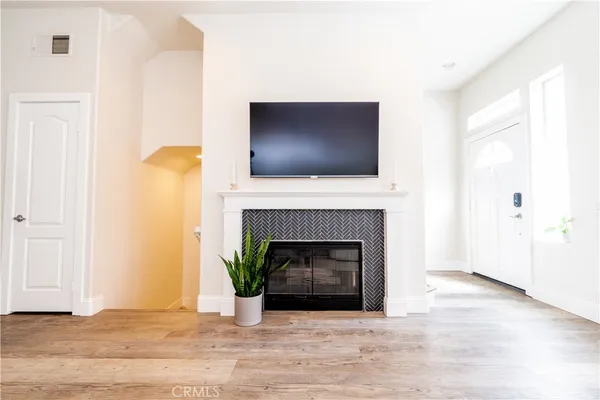 a living room with a fireplace and a flat screen tv