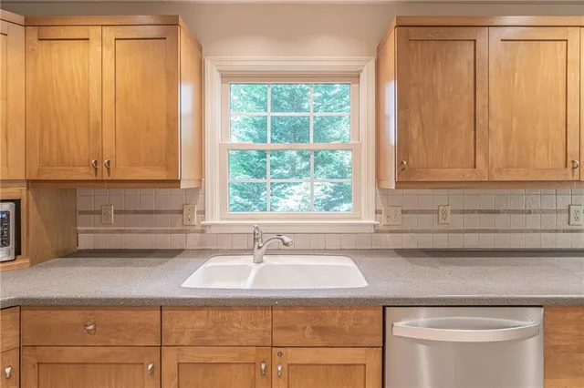 a sink sitting next to a window