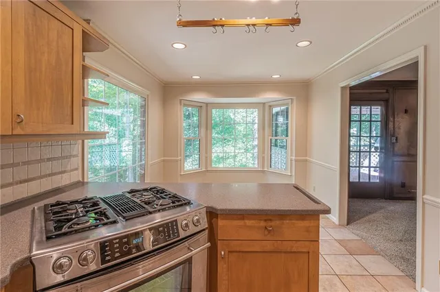 a stove top oven sitting inside of a kitchen