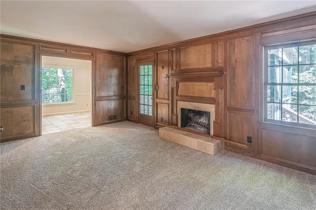 an empty room with furniture and a fireplace