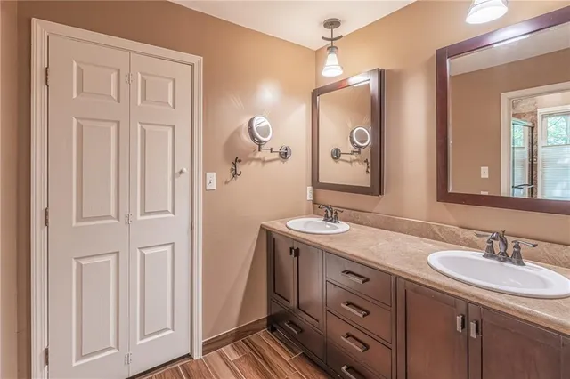 a bathroom with a granite countertop sink vanity and mirror