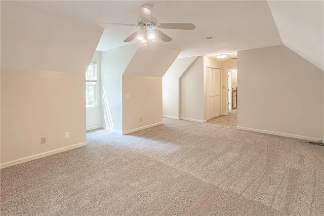 en empty room with windows and fan