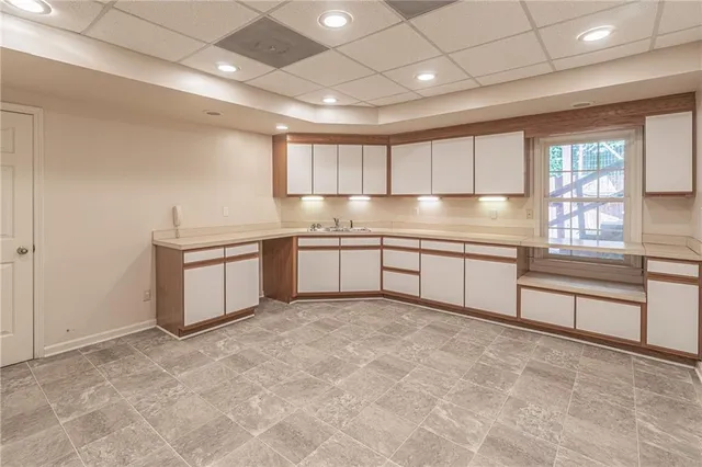 a kitchen with stainless steel appliances granite countertop a stove sink and cabinets
