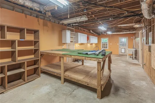 a room with furniture and stainless steel appliances