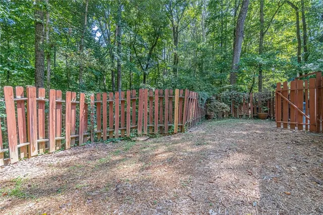 a wooden fence with trees in the background