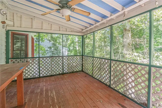 a view of a room with wooden floor and iron stairs