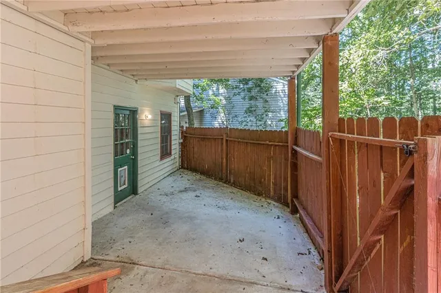 a view of a backyard with wooden fence