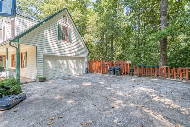 a view of a house with a yard and garage