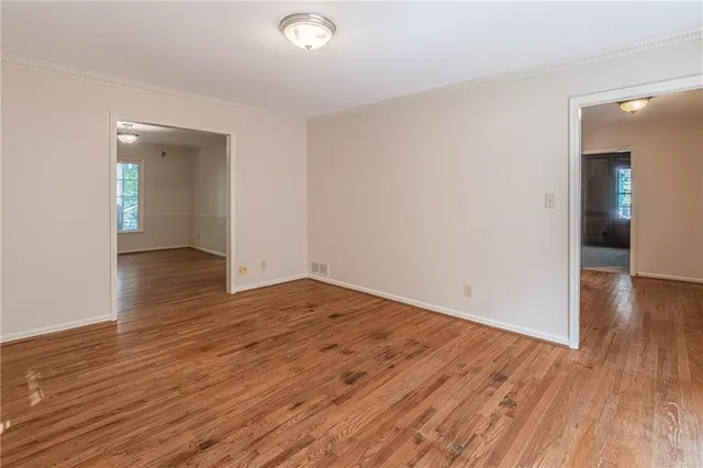 an empty room with wooden floor and closet