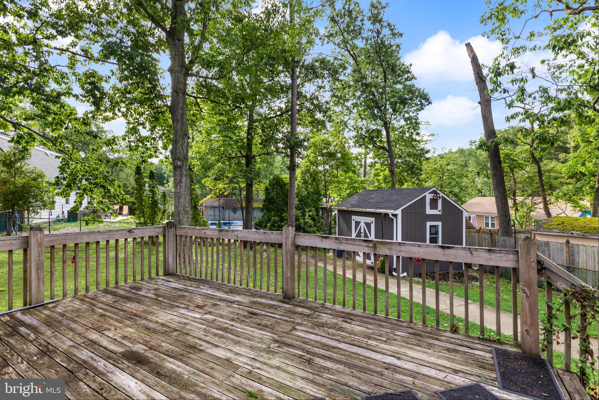 28 Windmill Clementon, NJ 08021 - Photo 27 of 28 a view of a wooden deck with large trees and wooden fence