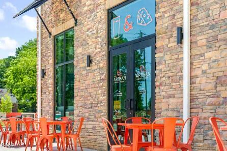 326 Short Ridge Way Rolesville, NC 27571 - Photo 18 of 22 a view of a brick wall with four windows