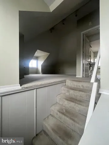 a view of staircase with white walls