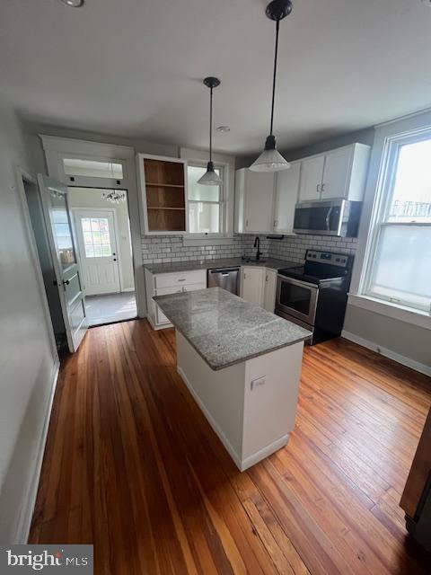 8 East Main Street, Unit MAIN Shiremanstown, PA 17011 - Photo 3 of 25 a kitchen with stainless steel appliances granite countertop a sink a stove and a wooden floor