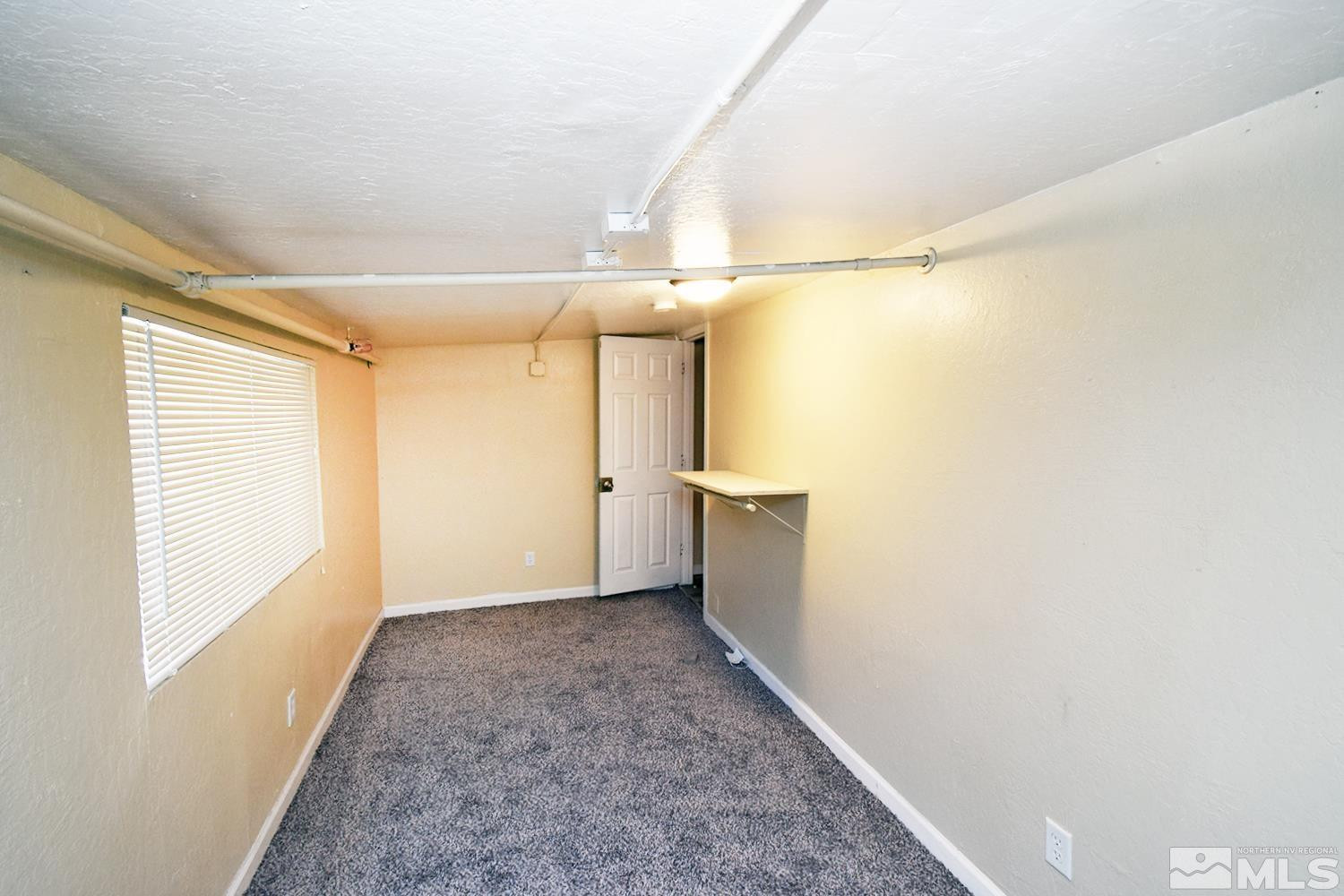486 Highland Avenue Reno, NV 89512 - Photo 15 of 33 a view of a hallway with wooden shelves