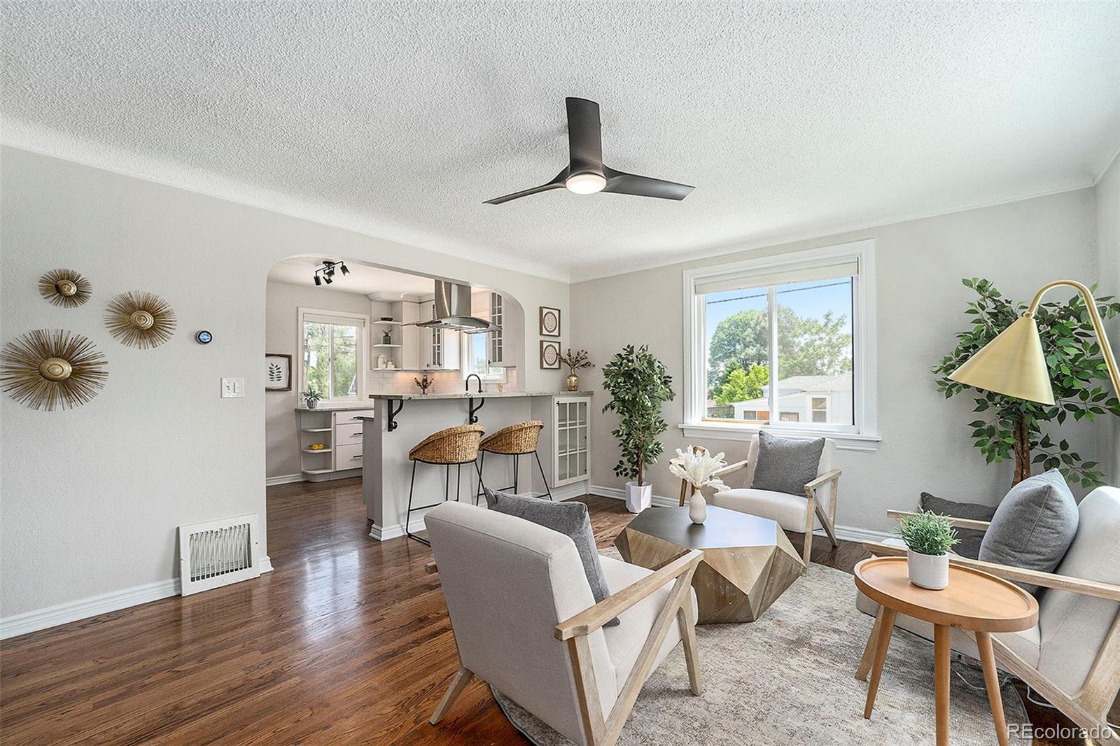 3002 Depew Street Wheat Ridge, CO 80214 - Photo 1 of 44 a living room with furniture a window and a chandelier