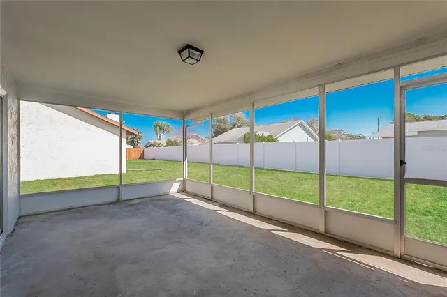 a view of an empty room with a floor to ceiling window