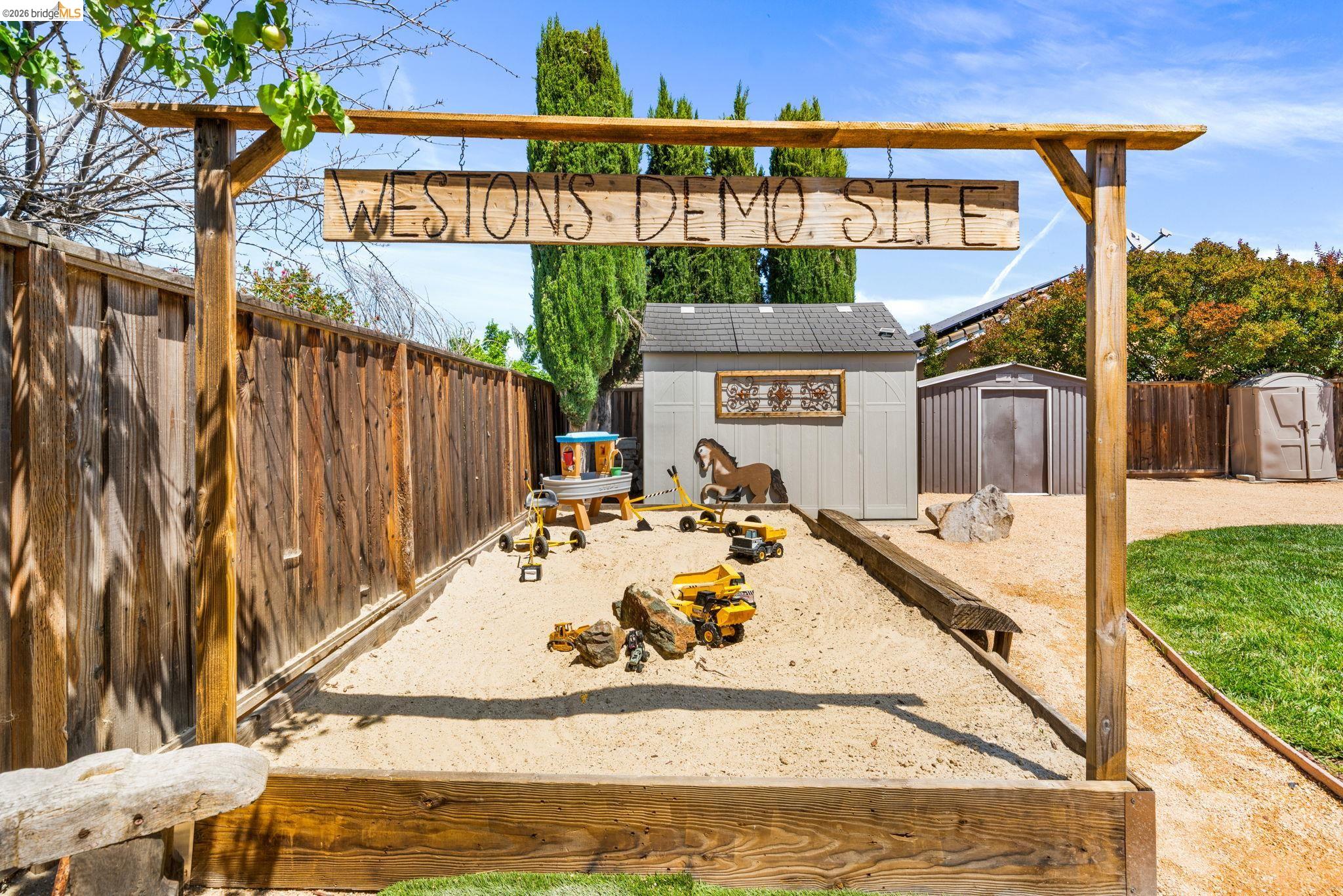 1186 El Rio Court Livermore, CA 94551 - Photo 34 of 60 Expansive sand play area featuring a raised wooden border and a decorative overhead wooden beam