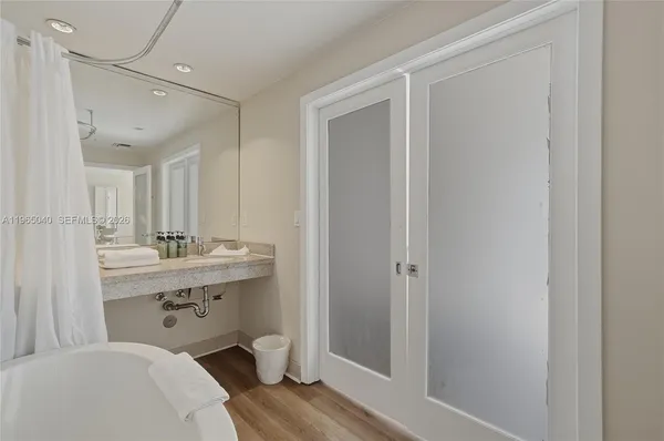 a room with a bed and a view of bathroom