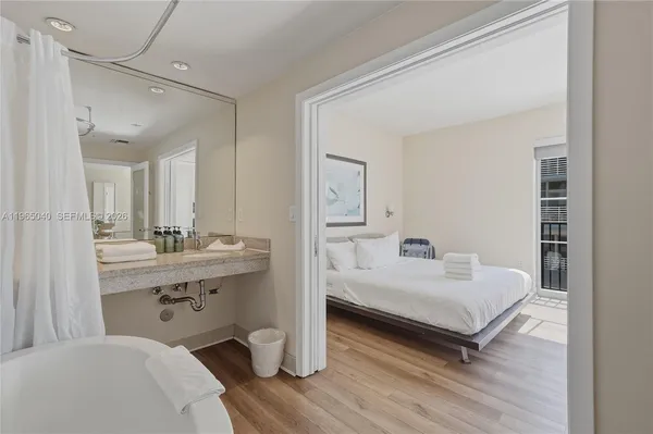 a bedroom with furniture and a wooden floor