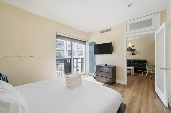 a bedroom with a bed and a window