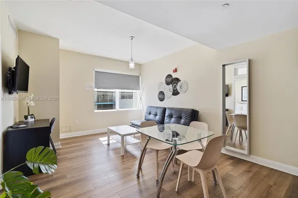 a dining room with furniture and wooden floor