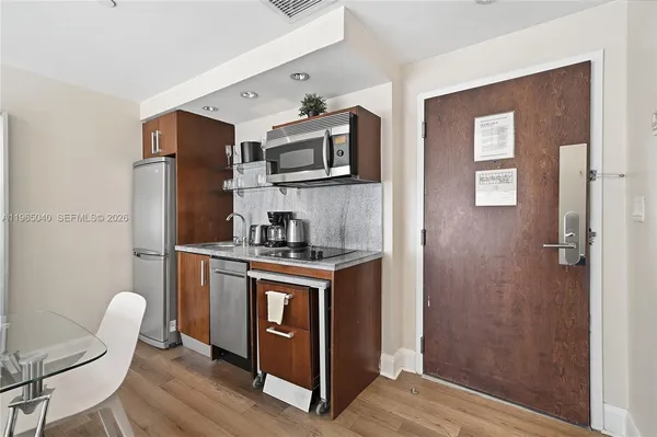 a kitchen with stainless steel appliances granite countertop a refrigerator stove and sink