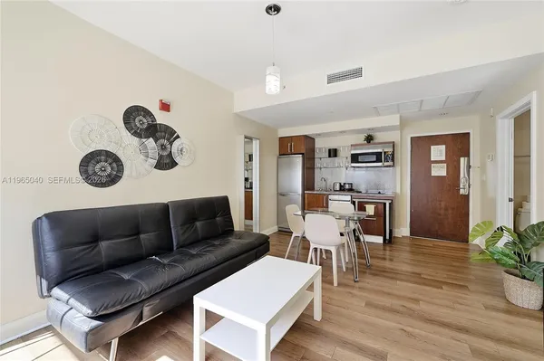 a living room with furniture and wooden floor