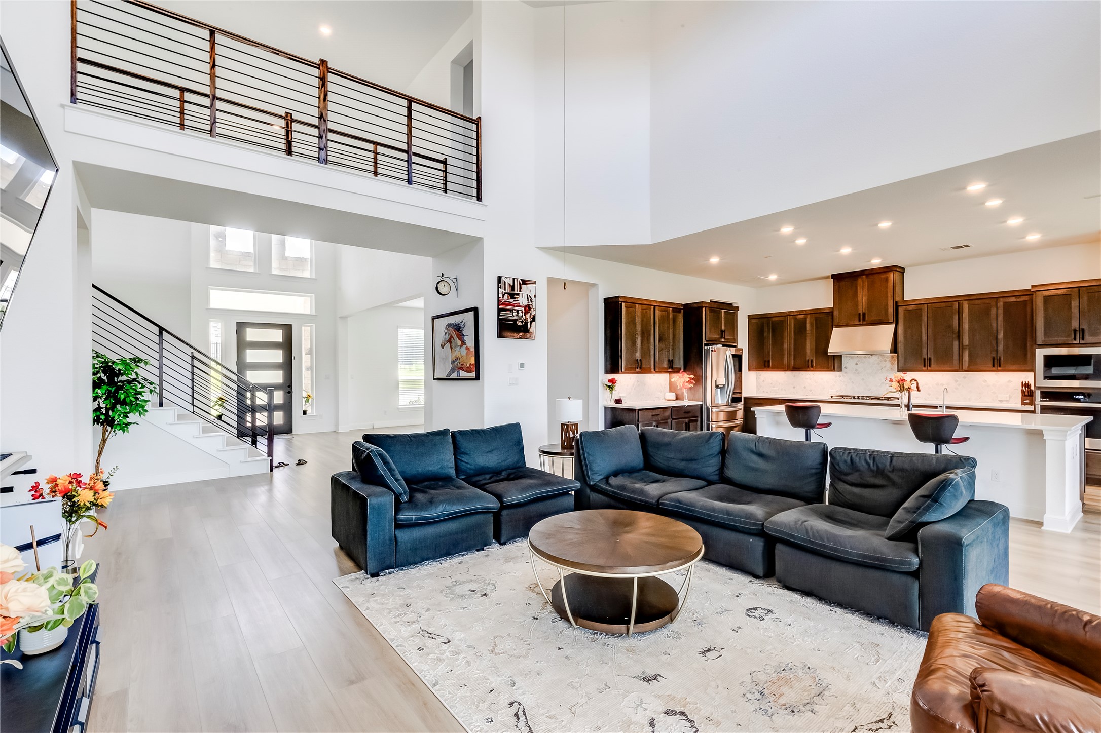 462 Old Stone Road Austin, TX 78737 - Photo 6 of 39 Living room with recessed lighting, light wood-style floors, and a high ceiling