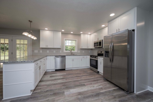445 Pocahontas Road Morrison, TN 37357 - Photo 2 of 16 a large kitchen with granite countertop a large counter top stainless steel appliances and cabinets
