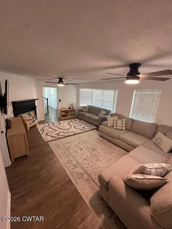 a living room with chairs and a flat screen tv