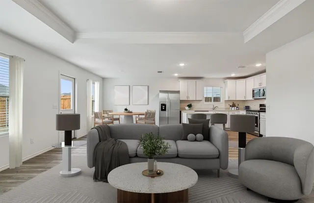 a living room with furniture and a dining table with wooden floor