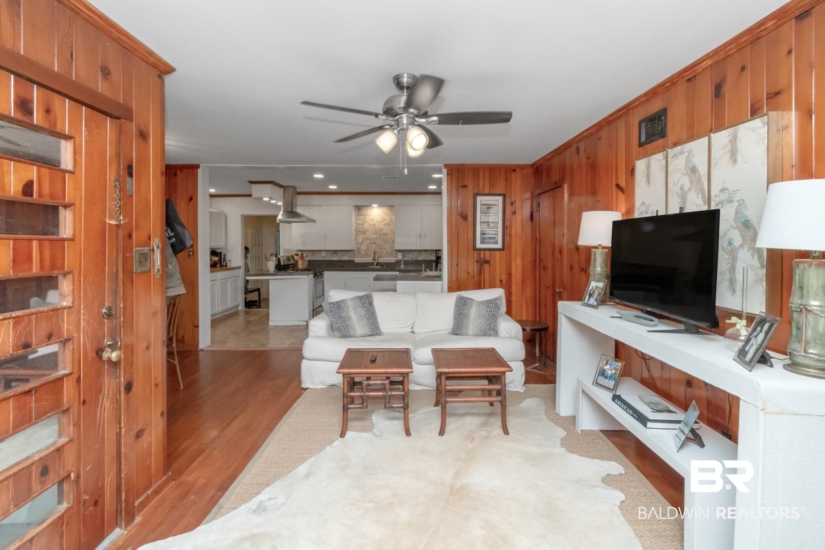 20 Kirby Street Mobile, AL 36607 - Photo 3 of 35 Living room featuring sink, light wood-type flooring, ceiling fan, and wood walls