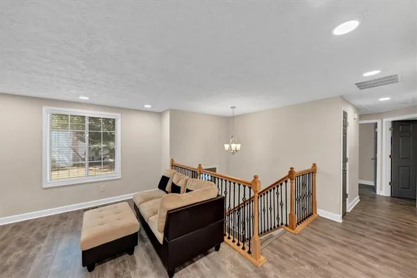 a view of a hallway with windows and stairs