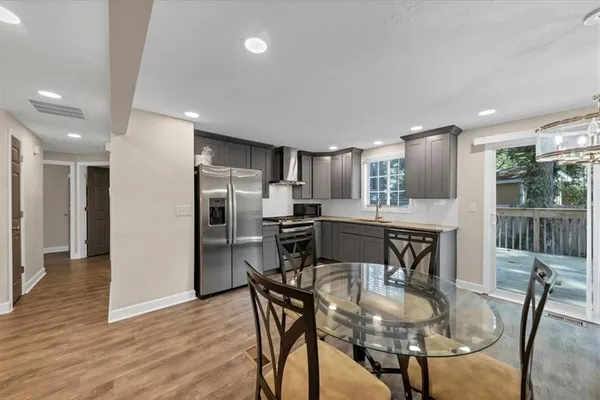 a kitchen with a table and chairs in it