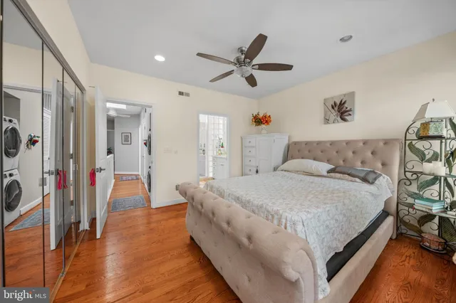 a spacious bedroom with a bed and a chandelier