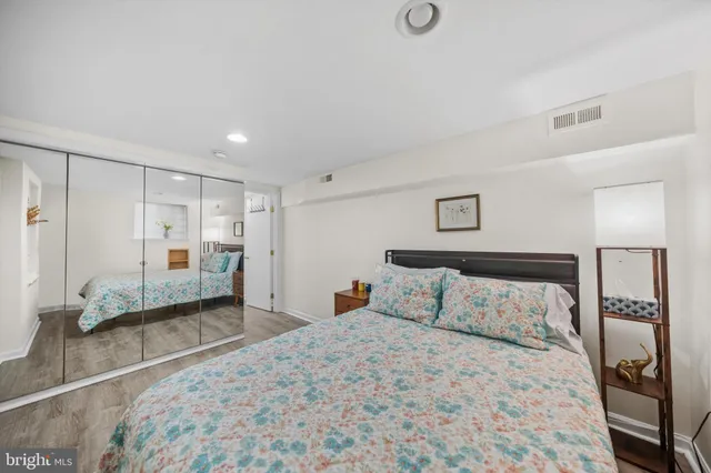 a bedroom with a bed and a mirror