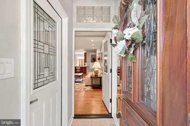 a view of a hallway and a livingroom with furniture