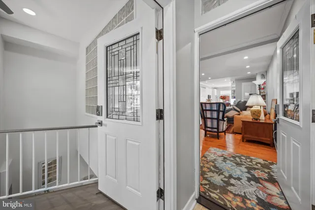 a view of a hallway with furniture and a livingroom view