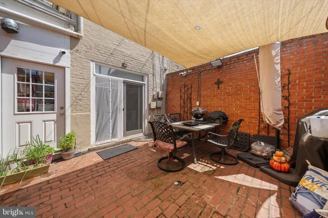 a backyard of a house with table and chairs