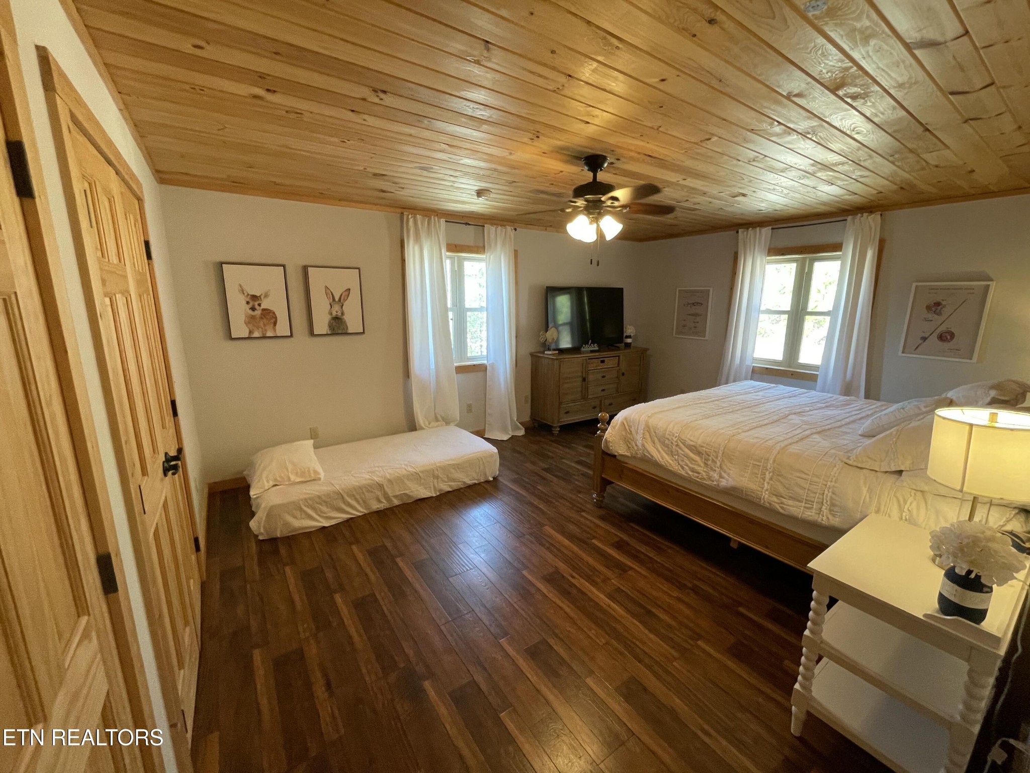 625 Bluff View Road New Tazewell, TN 37825 - Photo 19 of 57 a bedroom with a bed ceiling fan and a wooden floor