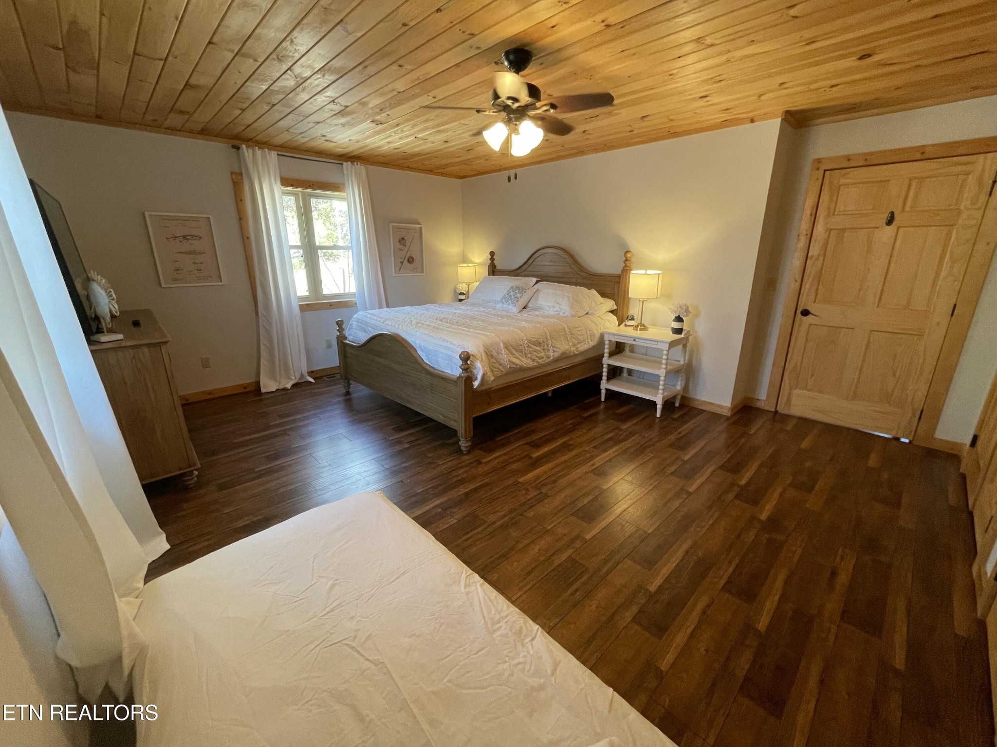 625 Bluff View Road New Tazewell, TN 37825 - Photo 20 of 57 a bedroom with a bed and a chandelier