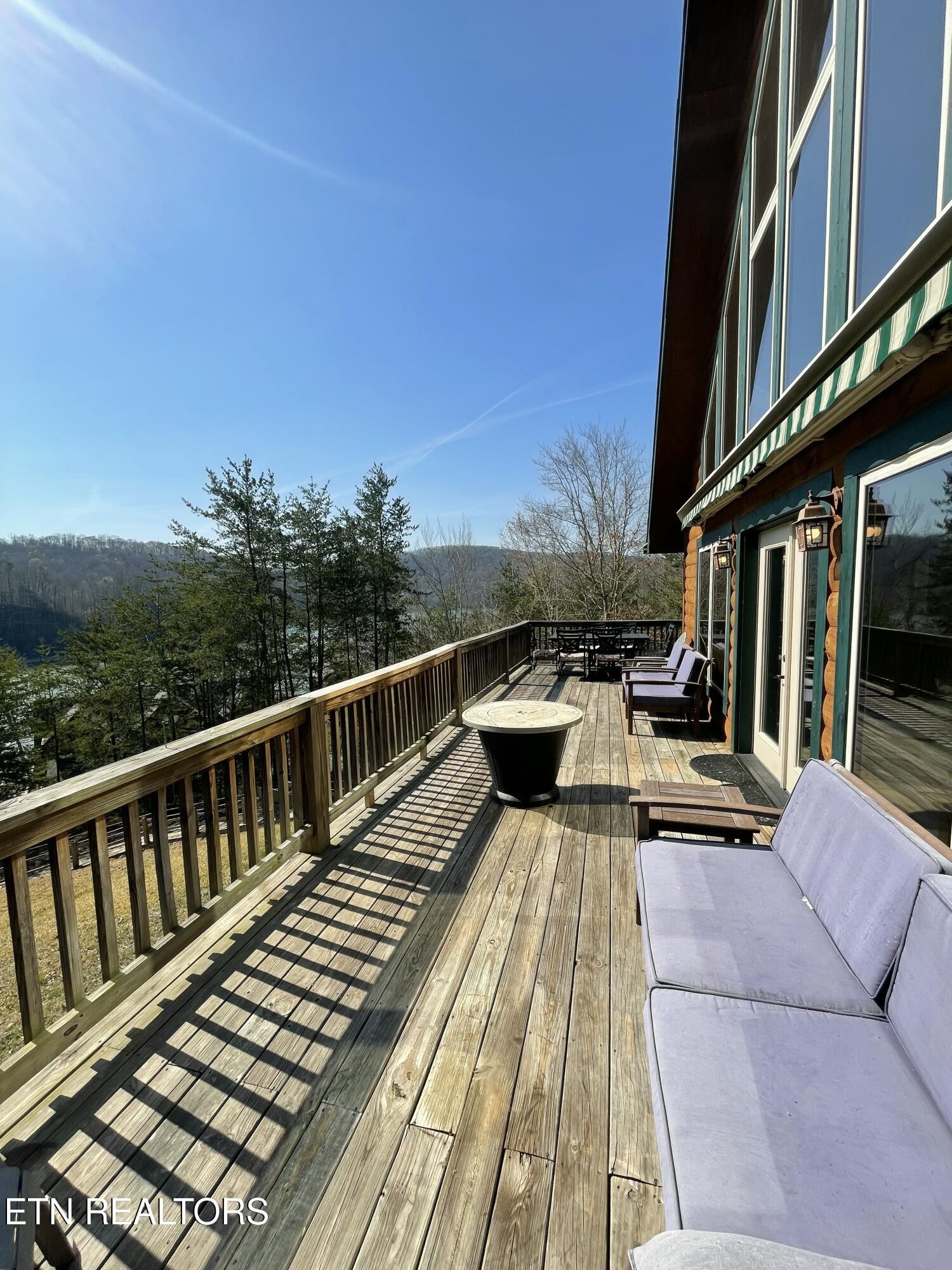 625 Bluff View Road New Tazewell, TN 37825 - Photo 43 of 57 a view of a roof deck with couches and wooden floor