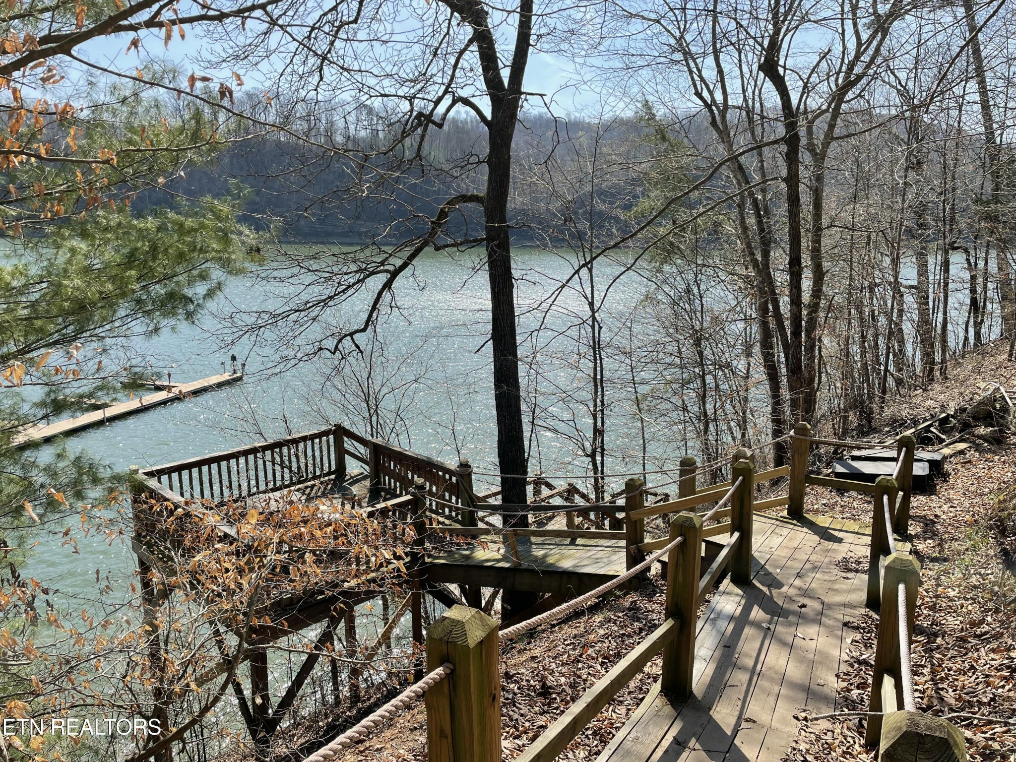 625 Bluff View Road New Tazewell, TN 37825 - Photo 47 of 57 a view of a roof deck with couches and wooden fence