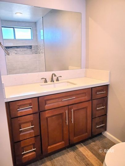 128 South Lilac Street Ridgecrest, CA 93555 - Photo 10 of 24 a bathroom with a sink and a mirror